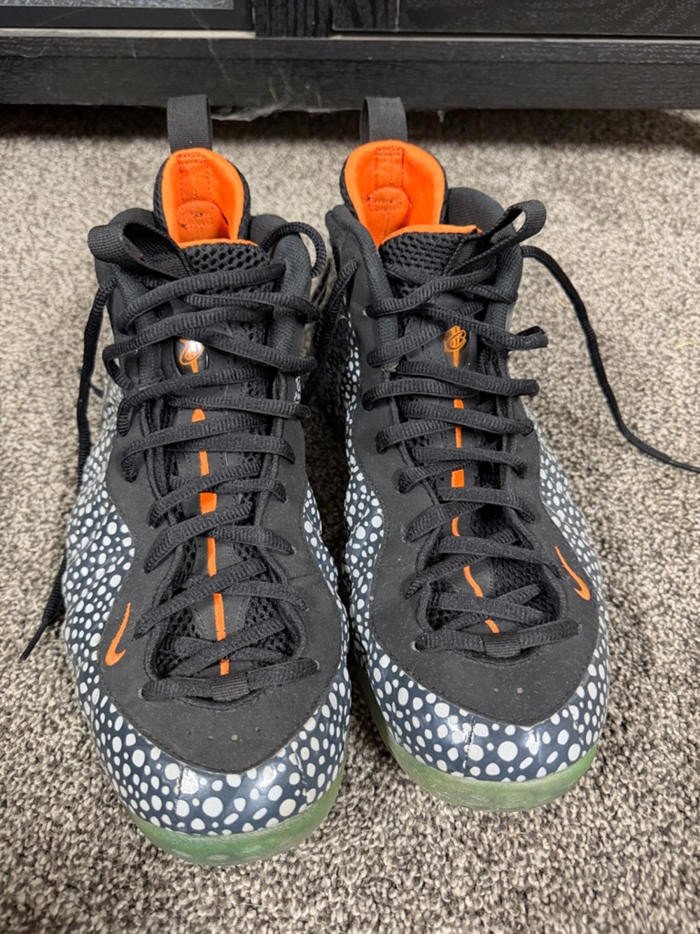 Nike Black Sneakers with Orange Accents and White Spot Pattern